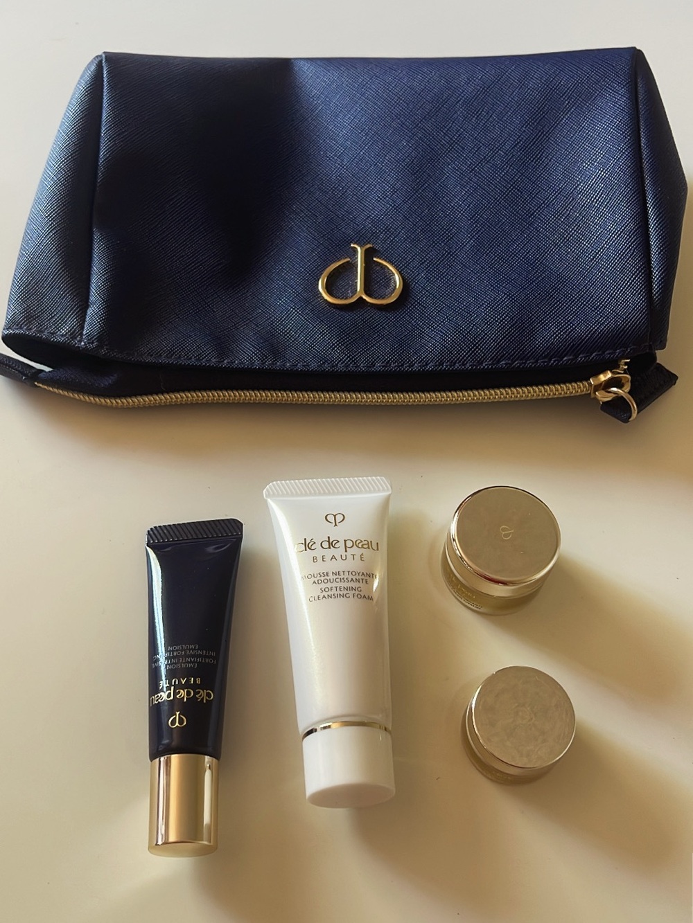 cle de peau navy small travel pouch with travel size skincare variety